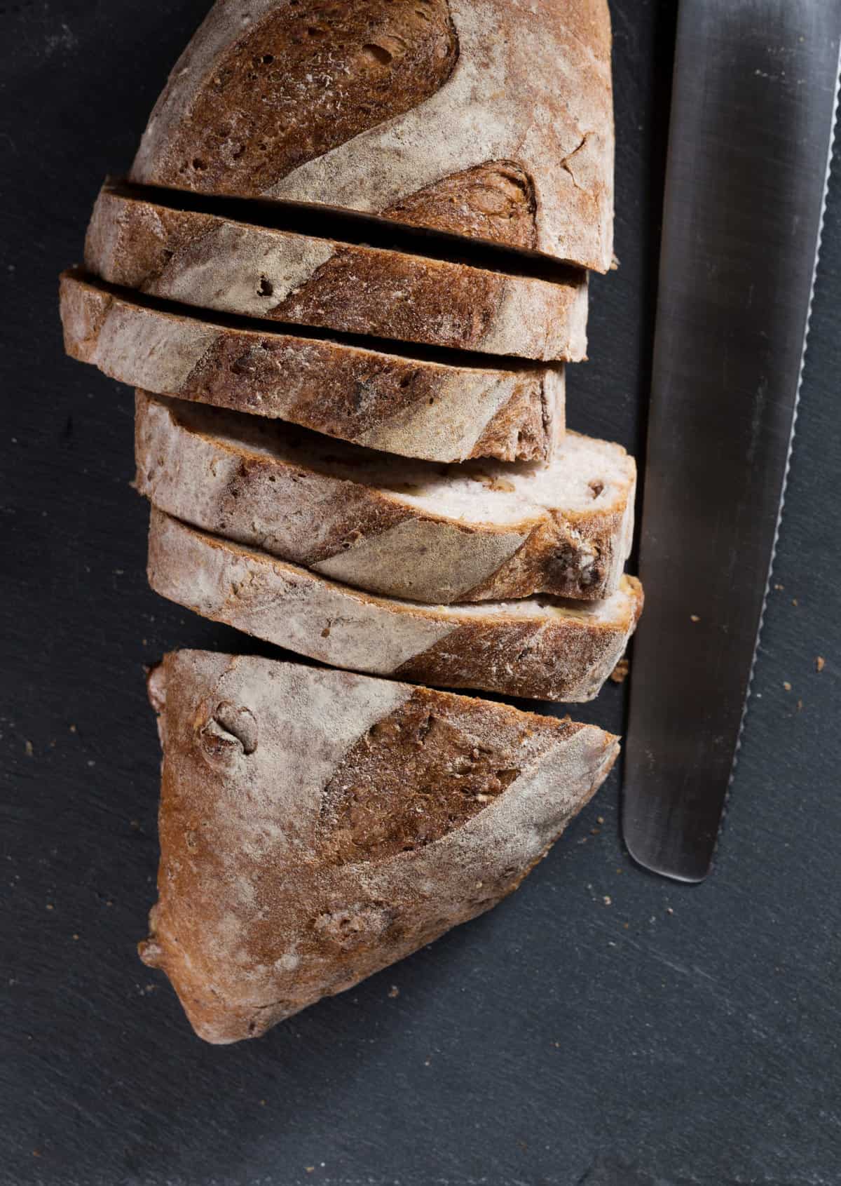 sliced bread loaf on Black Slate Board.